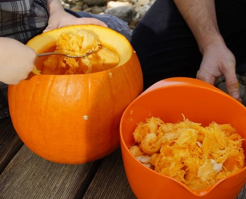 Scooping out the innards of a jack-o-lantern.
