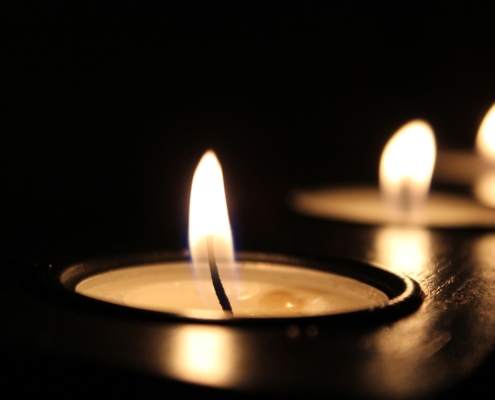 Photo of a burning tealight candle.